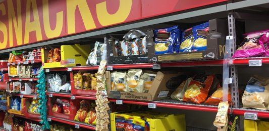 Es gibt viele Snacks im Supermarktregal und die Konkurrenz ist hart. Werbung ist da von großer Bedeutung für die Hersteller. Foto (Extra (Coop supermarket) Bergen Storsenter Norway 2017-11-16 snacks aisle): Wolfmann / Wikimedia Commons (CC BY-SA 4.0) (Ausschnitt mit verwischten Schriftzügen)