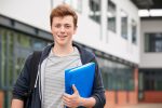 Portrait,Of,Male,Student,Standing,Outside,College,Building