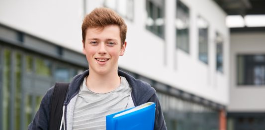 Portrait,Of,Male,Student,Standing,Outside,College,Building