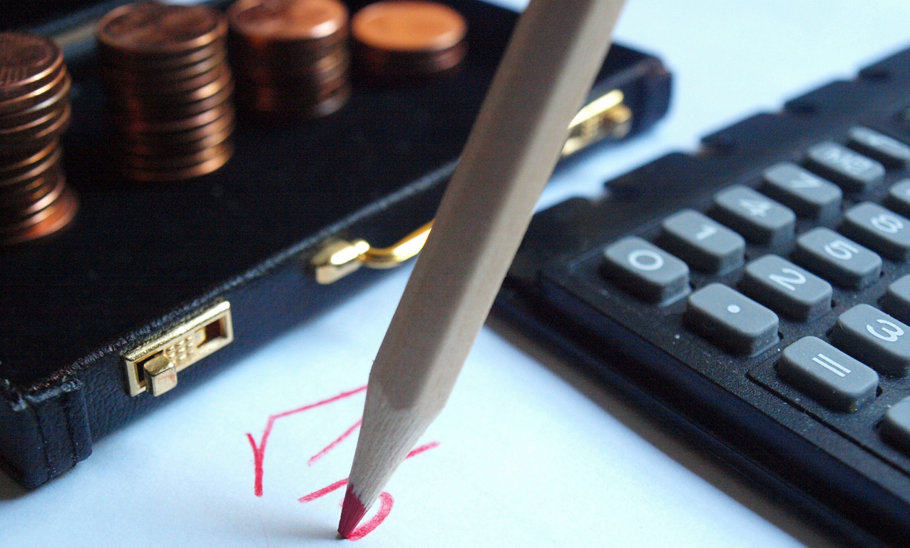 Geldkoffer, Taschenrechner und Rotstift